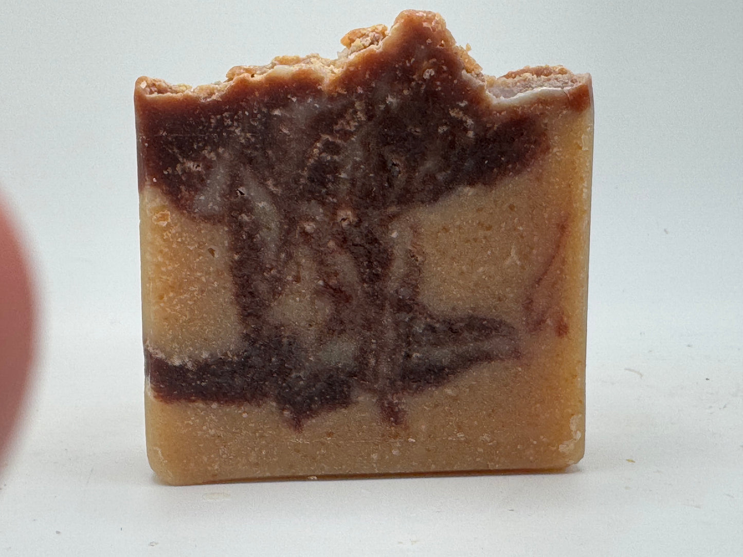Marbled brown and beige soap bar on a white background