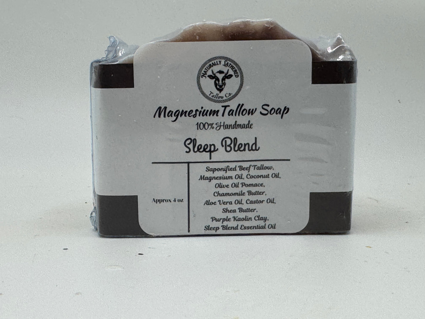 Bar of magnesium tallow soap with a label on a white background