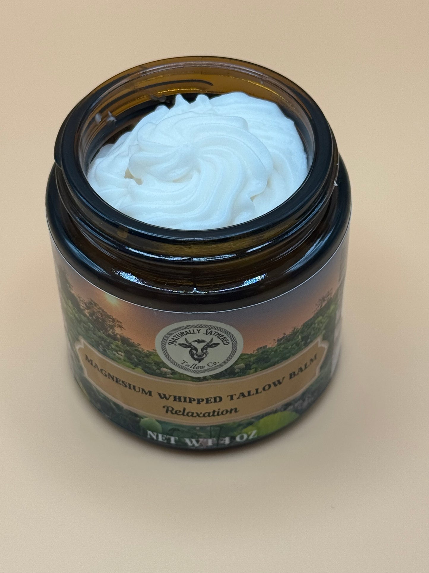 Jar of whipped balm with a label on a beige background