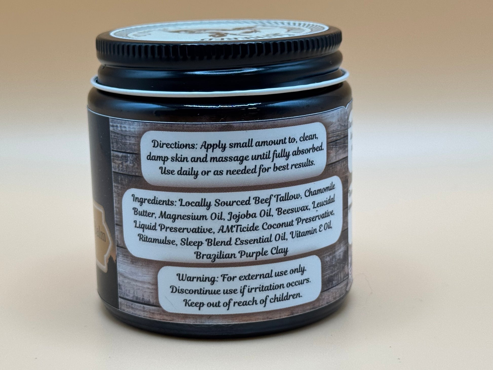 Jar of cream with label on a beige background